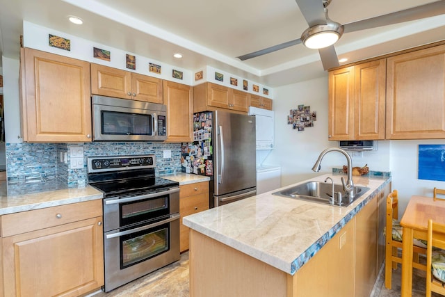 kitchen featuring sink, ceiling fan, backsplash, stainless steel appliances, and light stone counters