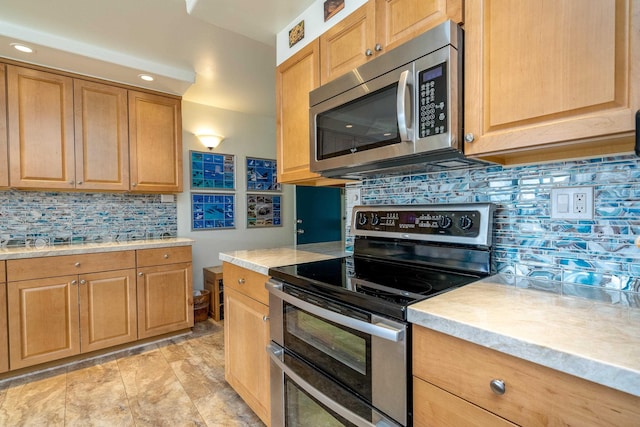 kitchen with tasteful backsplash and stainless steel appliances