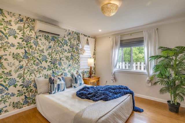 bedroom featuring a wall unit AC, multiple windows, ornamental molding, and wood finished floors