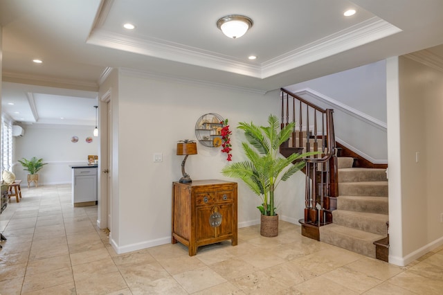 interior space with stairs, baseboards, a raised ceiling, and crown molding