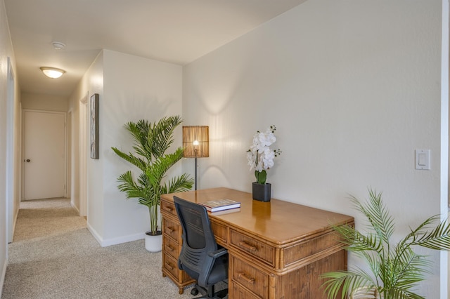 office area with light carpet and baseboards