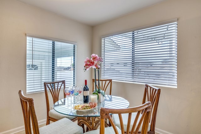 dining space featuring plenty of natural light and baseboards