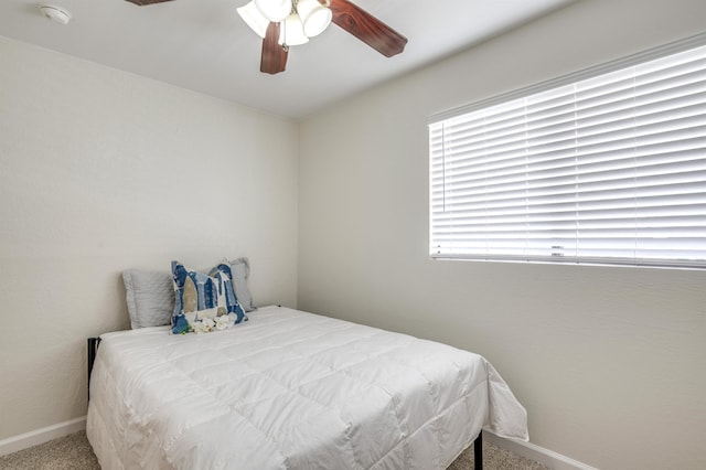 bedroom featuring carpet floors, baseboards, and a ceiling fan