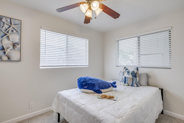bedroom featuring multiple windows, carpet, and baseboards