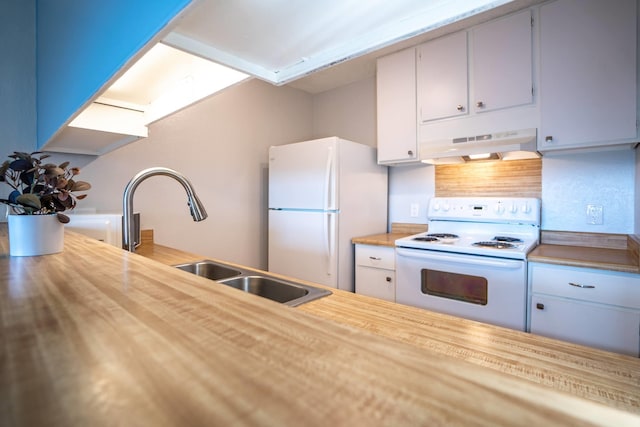 kitchen with white appliances, sink, and wooden counters