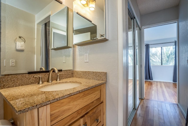 bathroom with vanity and hardwood / wood-style flooring