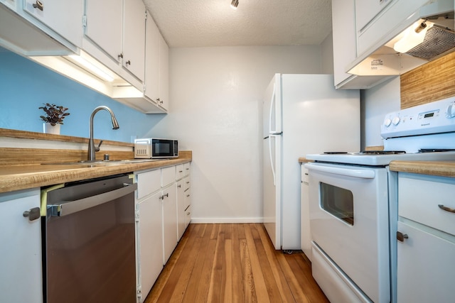 kitchen featuring dishwasher, white cabinets, white electric range, sink, and a textured ceiling