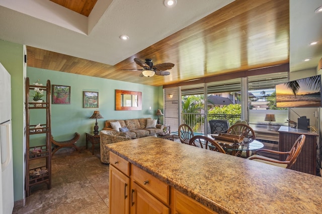 kitchen featuring ceiling fan and wooden ceiling