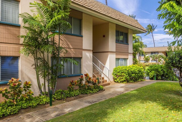 entrance to property with a yard