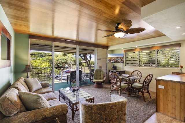 sunroom / solarium featuring ceiling fan and wooden ceiling