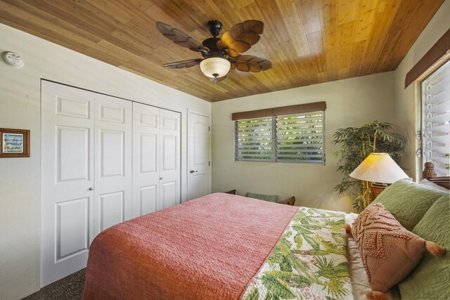 bedroom featuring ceiling fan, a closet, wood ceiling, and multiple windows