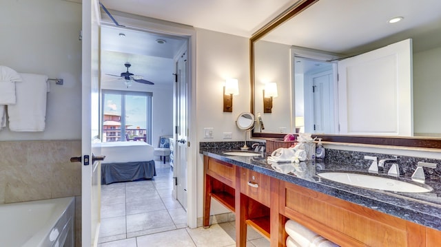 bathroom featuring ceiling fan, vanity, a bathing tub, and tile patterned flooring