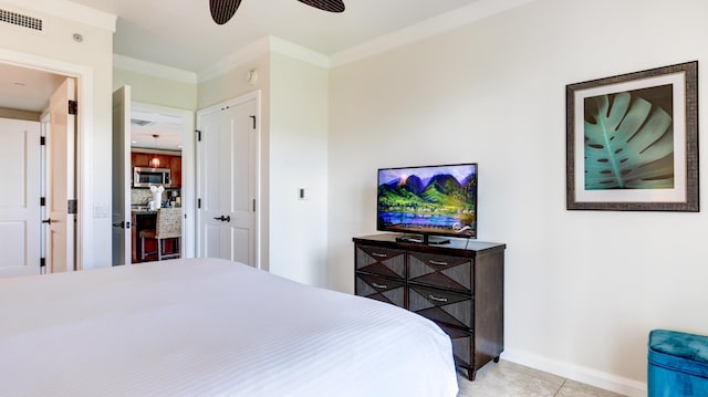 bedroom featuring ceiling fan, crown molding, and light tile patterned flooring