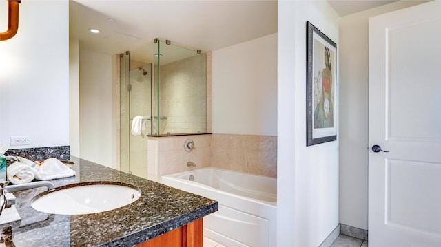 bathroom with shower with separate bathtub, tile patterned floors, and vanity