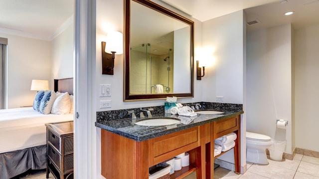 bathroom featuring tile patterned flooring, vanity, toilet, a shower with shower door, and crown molding