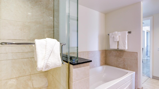 bathroom featuring tile patterned floors and plus walk in shower