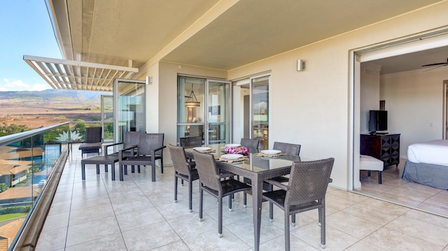 view of patio / terrace with a balcony and a pergola