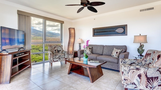 tiled living room with ceiling fan and ornamental molding