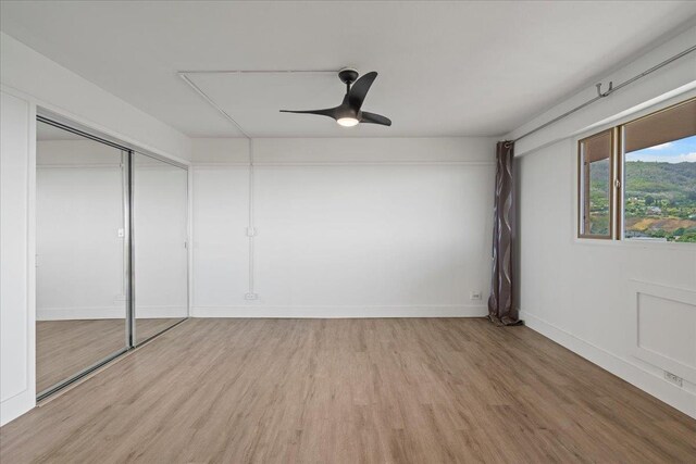 2158 Main St Unit 704, Wailuku, HI 96793 - unfurnished bedroom featuring light wood-type flooring, a ceiling fan, and a closet