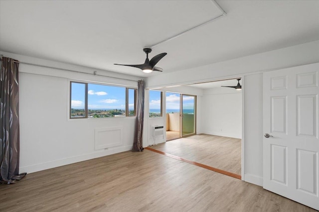 2158 Main St Unit 704, Wailuku, HI 96793 - spare room with a ceiling fan, light wood-style flooring, and plenty of natural light