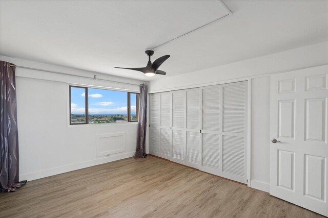 2158 Main St Unit 704, Wailuku, HI 96793 - unfurnished bedroom with light wood-style floors, a closet, and a ceiling fan