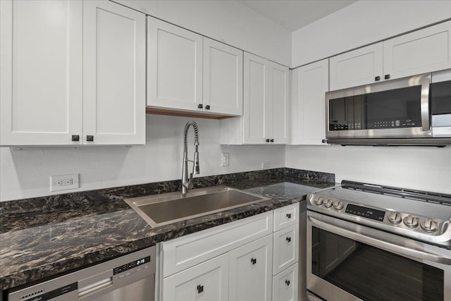 2158 Main St Unit 704, Wailuku, HI 96793 - kitchen featuring appliances with stainless steel finishes, white cabinetry, and dark stone countertops