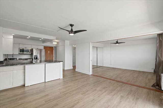 2158 Main St Unit 704, Wailuku, HI 96793 - kitchen with appliances with stainless steel finishes, a ceiling fan, light wood-style flooring, and open floor plan