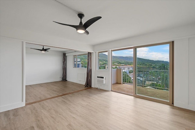 2158 Main St Unit 704, Wailuku, HI 96793 - unfurnished room with ceiling fan, wood finished floors, and a wall unit AC