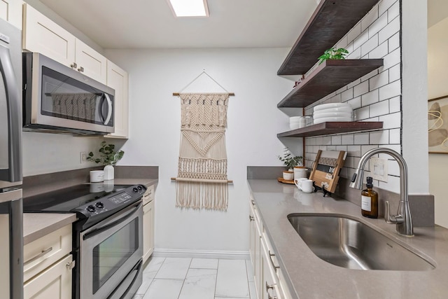 480 Kenolio Rd Unit 13-101, Kihei, HI 96753 - kitchen with appliances with stainless steel finishes, a sink, open shelves, light marble finish floors, and white cabinets