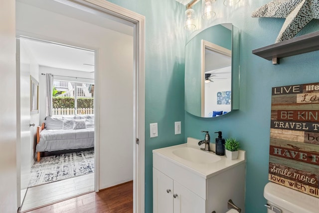 480 Kenolio Rd Unit 13-101, Kihei, HI 96753 - bathroom with vanity, wood finished floors, and toilet