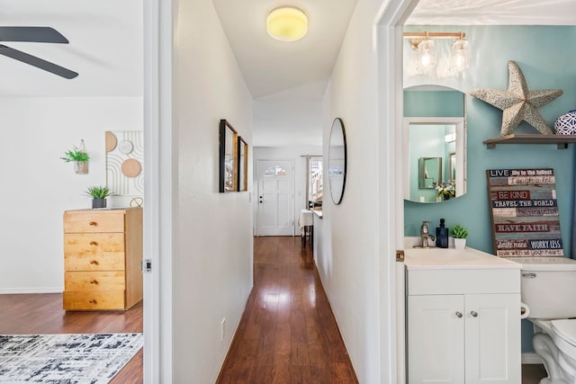 480 Kenolio Rd Unit 13-101, Kihei, HI 96753 - hallway featuring dark wood finished floors and a sink