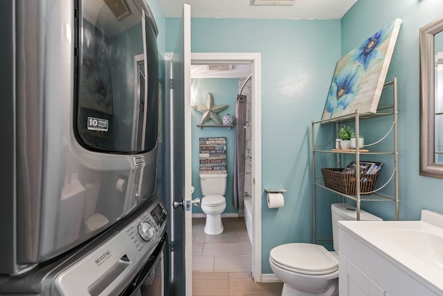 480 Kenolio Rd Unit 13-101, Kihei, HI 96753 - bathroom with stacked washing machine and dryer, toilet, vanity, and shower / tub combo