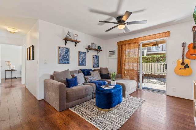 480 Kenolio Rd Unit 13-101, Kihei, HI 96753 - living area featuring dark wood-style flooring, ceiling fan, a wall mounted AC, and baseboards