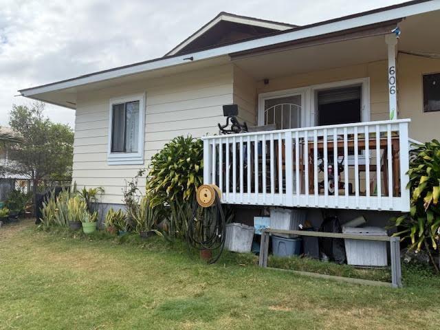 rear view of property with a lawn