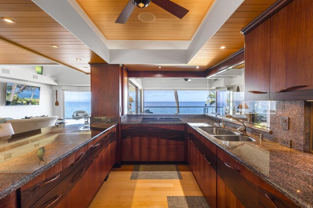 4000 Wailea Alanui Dr Unit 502, Kihei, HI 96753 - kitchen featuring wooden ceiling, a sink, light wood-type flooring, dark stone countertops, and a water view