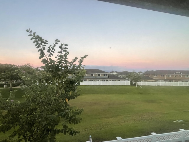 view of yard at dusk