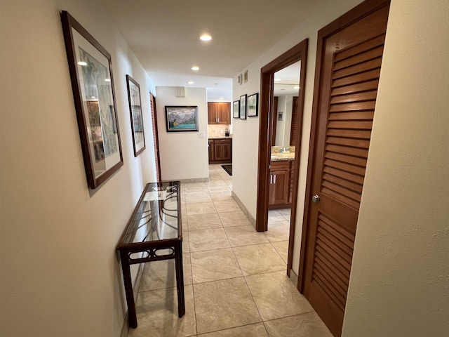 corridor with light tile patterned flooring and recessed lighting