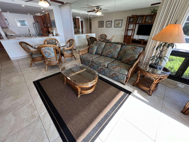 living area featuring a ceiling fan and light tile patterned flooring