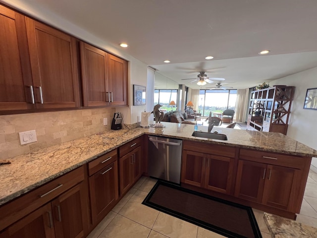 kitchen featuring a sink, light tile patterned flooring, tasteful backsplash, a peninsula, and dishwasher