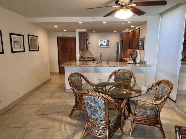 dining area with light tile patterned flooring, recessed lighting, a ceiling fan, and baseboards