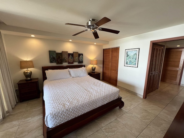bedroom with light tile patterned floors, recessed lighting, and a closet