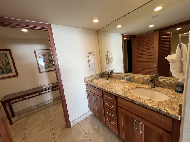 bathroom featuring recessed lighting, tile patterned flooring, a sink, and double vanity