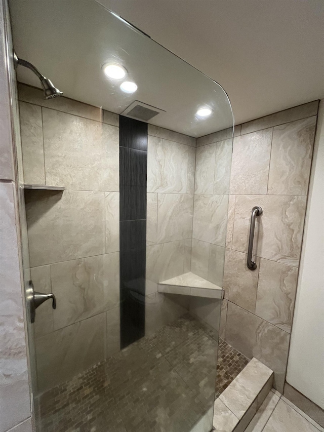 full bathroom with a tile shower and tile patterned flooring