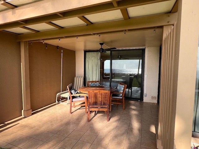 interior space with ceiling fan and tile patterned flooring