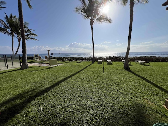 surrounding community featuring a lawn and a water view
