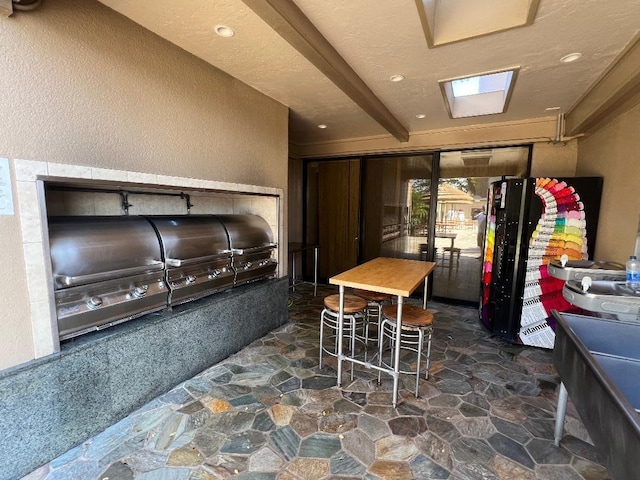 interior space featuring recessed lighting, stone floors, and a textured wall