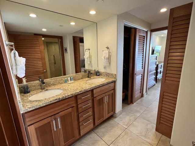 full bath featuring tile patterned floors, recessed lighting, a shower stall, and a sink