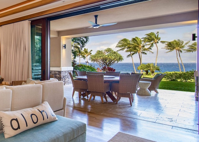 view of patio / terrace with ceiling fan, a water view, and outdoor lounge area