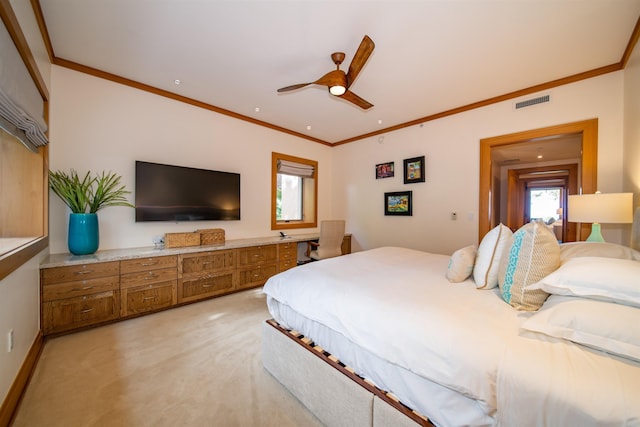 carpeted bedroom featuring ceiling fan and crown molding