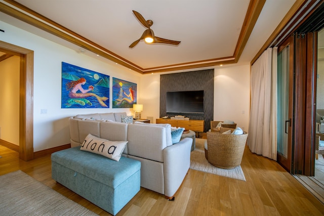 living room with ceiling fan, ornamental molding, and light hardwood / wood-style floors